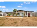 Charming single-story home with well-maintained landscaping and a welcoming, light-blue front door at 1529 79Th N Ave, St Petersburg, FL 33702