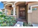 Inviting front entrance with double doors, decorative wreaths, and manicured landscaping at 15724 Ibisridge Dr, Lithia, FL 33547