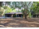 Expansive home with large lot showcasing mature trees and natural surroundings for a private setting at 16536 Caldwell Ln, Spring Hill, FL 34610