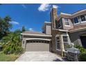 Two-car garage with stone chimney at 16637 Ashton Green Dr, Lutz, FL 33558