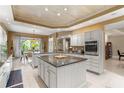 Open-concept kitchen with a center island, stainless steel appliances, and an adjacent dining area at 1750 Arabian Ln, Palm Harbor, FL 34685