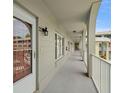 Exterior hallway featuring an open design with gray paint and black lighting at 2228 Swedish Dr # 22, Clearwater, FL 33763