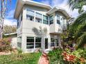 Rear view showcasing the home's architectural details, lush landscaping, and a spiral staircase at 246 22Nd Ne Ave, St Petersburg, FL 33704