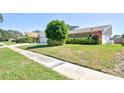 A charming single-story home with a well-maintained lawn, showcasing a classic brick exterior at 2675 Firestone Dr, Clearwater, FL 33761