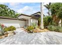 House with mid-century modern facade, featuring white tiled walls, brown trim, and mature trees at 3130 Walnut Ne St, St Petersburg, FL 33704