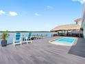 Stunning backyard with a private pool, tiki bar, and dock overlooking the water at 326 176Th Avenue Cir, Redington Shores, FL 33708