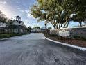 Stone community entrance featuring lush landscaping and signage: The Bentley at Cobbs Landing at 3260 Haviland Ct # 202, Palm Harbor, FL 34684