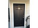 Black front door with gold number 202, trimmed in white at 3260 Haviland Ct # 202, Palm Harbor, FL 34684
