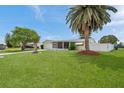 Well-maintained lawn, mature trees, and tidy landscaping enhancing the curb appeal of this charming home at 3716 Carioca Rd, Holiday, FL 34691