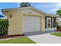 A bright garage door and well-maintained front entrance create a welcoming facade to this charming home at 3716 Carioca Rd, Holiday, FL 34691