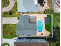 Aerial view of a backyard featuring a refreshing swimming pool, manicured landscaping, and privacy fencing at 3801 Huntington Ne St, St Petersburg, FL 33703