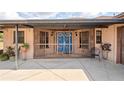 Charming enclosed front porch with blue double doors at 39427 Comstock Ln, Zephyrhills, FL 33540