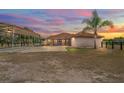 Lovely ranch style home with covered parking and a well maintained yard at sunset at 39427 Comstock Ln, Zephyrhills, FL 33540