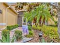A walkway leads to a screened front entrance with tasteful landscaping and exterior lighting at 4949 Marble Springs Cir, Wimauma, FL 33598
