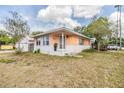 Charming single-story home showcasing a brick facade and an inviting front porch with landscaped lawn at 5101 13Th S Ave, Gulfport, FL 33707