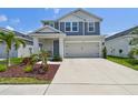 Charming two-story home featuring a well-manicured lawn, covered porch and a two car garage at 5437 Del Coronado Dr, Apollo Beach, FL 33572