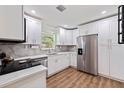 Modern kitchen with stainless steel appliances, white cabinets, and stylish countertops at 5932 Mckee Lake N Dr, St Petersburg, FL 33709