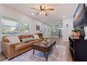 Cozy living room with a ceiling fan, modern furniture, and great natural light at 5932 Mckee Lake N Dr, St Petersburg, FL 33709
