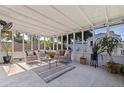 Bright sunroom featuring neutral furniture, great natural light, and outdoor views at 5932 Mckee Lake N Dr, St Petersburg, FL 33709