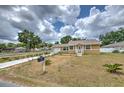 Lovely one-story home featuring a well-manicured yard and a welcoming entryway at 5939 14Th St, Zephyrhills, FL 33542