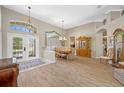 Spacious formal dining room featuring hardwood floors, a modern chandelier, and plenty of natural light at 6104 Cognac Cir, Lutz, FL 33558