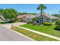 Charming home with a well-manicured lawn, a three-car garage, and a paver driveway at 6104 Cognac Cir, Lutz, FL 33558