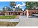 Lovely one-story home featuring a carport, well-maintained lawn, and inviting front entrance at 7242 55Th N Ave, St Petersburg, FL 33709