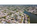 An aerial shot highlighting the proximity of homes to the canal, illustrating the community's waterfront access and layout at 7534 Culberson Dr, Port Richey, FL 34668
