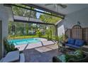 Enjoy the outdoors in this screened-in lanai with a refreshing pool, perfect for relaxation and entertaining at 7649 Nottinghill Sky Dr, Apollo Beach, FL 33572