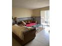 Comfortable living room with tile floors and sliding glass doors to a patio at 9481 Highland Oak Dr # 1202, Tampa, FL 33647
