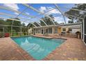 Screened-in pool and outdoor living space, ideal for relaxing or entertaining at 1703 Ryan Dr, Lutz, FL 33549