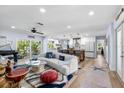 Open-concept living area featuring stylish furnishings and seamless flow to the kitchen at 10515 Hetrick W Cir, Largo, FL 33774