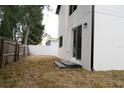 A partially fenced backyard featuring new construction and a sliding glass door at 12484 Cross St, Largo, FL 33773