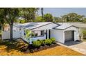 A charming house with new landscaping and stone paver driveway on a sunny day at 1710 Shore Acres Ne Blvd, St Petersburg, FL 33703