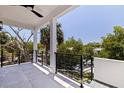 Enjoy the outdoors with a spacious covered balcony with black railing and tree views at 1811 Bayou Grande Ne Blvd, St Petersburg, FL 33703