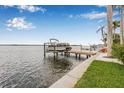 Scenic view of private boat dock with boat lift, overlooking the beautiful waterfront at 1819 Bayou Grande Ne Blvd, St Petersburg, FL 33703