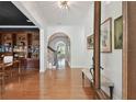 Bright foyer with gleaming hardwood floors and archways leading to the home's living spaces at 1940 Floresta View Dr, Tampa, FL 33618