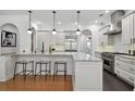 Gourmet kitchen featuring granite countertops, stainless steel appliances, and modern pendant lighting at 1940 Floresta View Dr, Tampa, FL 33618