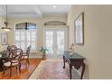 Bright foyer featuring tile flooring, shuttered windows, and an elegant console table at 19830 Strathmore Pl, Land O Lakes, FL 34638