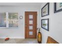 Bright foyer with a modern front door, tiled floors, and decorative artwork adding a stylish touch at 1990 59Th N St, St Petersburg, FL 33710
