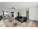 Staged living room flows into dining area with hardwood floors, contemporary decor and an open floorplan at 20413 Keene Rd, Wimauma, FL 33598