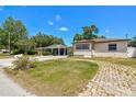 Single-story home with a cozy front yard and convenient carport at 3007 Aileen W St, Tampa, FL 33607