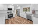 Bright kitchen with stainless steel appliances, white cabinets, and views to the backyard at 3079 Osprey Ln, Clearwater, FL 33762