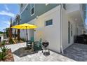 Relaxing patio with a grill, umbrella, outdoor seating, and tasteful hardscaping at 3101 4Th N Ter, St Petersburg, FL 33713