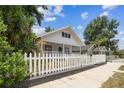 Charming home with a white picket fence, beautiful green plants, and inviting curb appeal at 3806 N Tampa St, Tampa, FL 33603