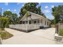 Charming home with a white picket fence, beautiful green plants, and inviting curb appeal at 3806 N Tampa St, Tampa, FL 33603