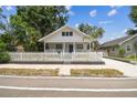 Charming home with a white picket fence, manicured lawn, and welcoming front porch at 3806 N Tampa St, Tampa, FL 33603