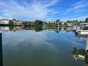 Beautiful waterfront view featuring multiple luxury homes and a dockside boat at 4 W Spanish Main St, Tampa, FL 33609