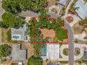 Aerial view of the property showcasing its location on a corner lot, surrounded by lush greenery and mature trees at 4465 1St Ne Way, St Petersburg, FL 33703
