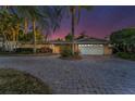 Charming exterior view of a well-maintained home, featuring a spacious driveway, attached garage and tropical landscaping at 4772 Dover Ne St, St Petersburg, FL 33703